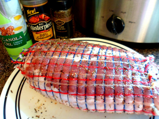 Rub BBQ seasoning and thyme all over the pork roast.