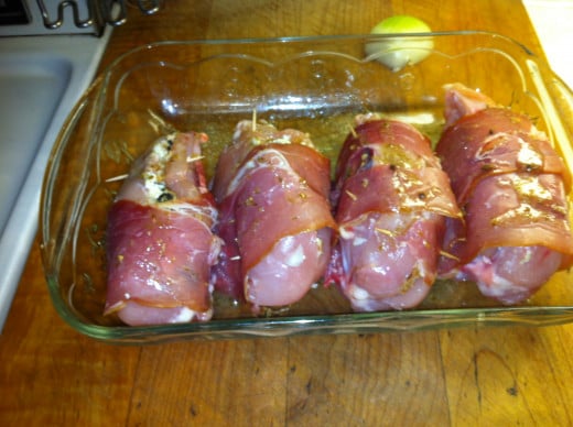 Four chicken breasts stuffed and ready to go into the oven.