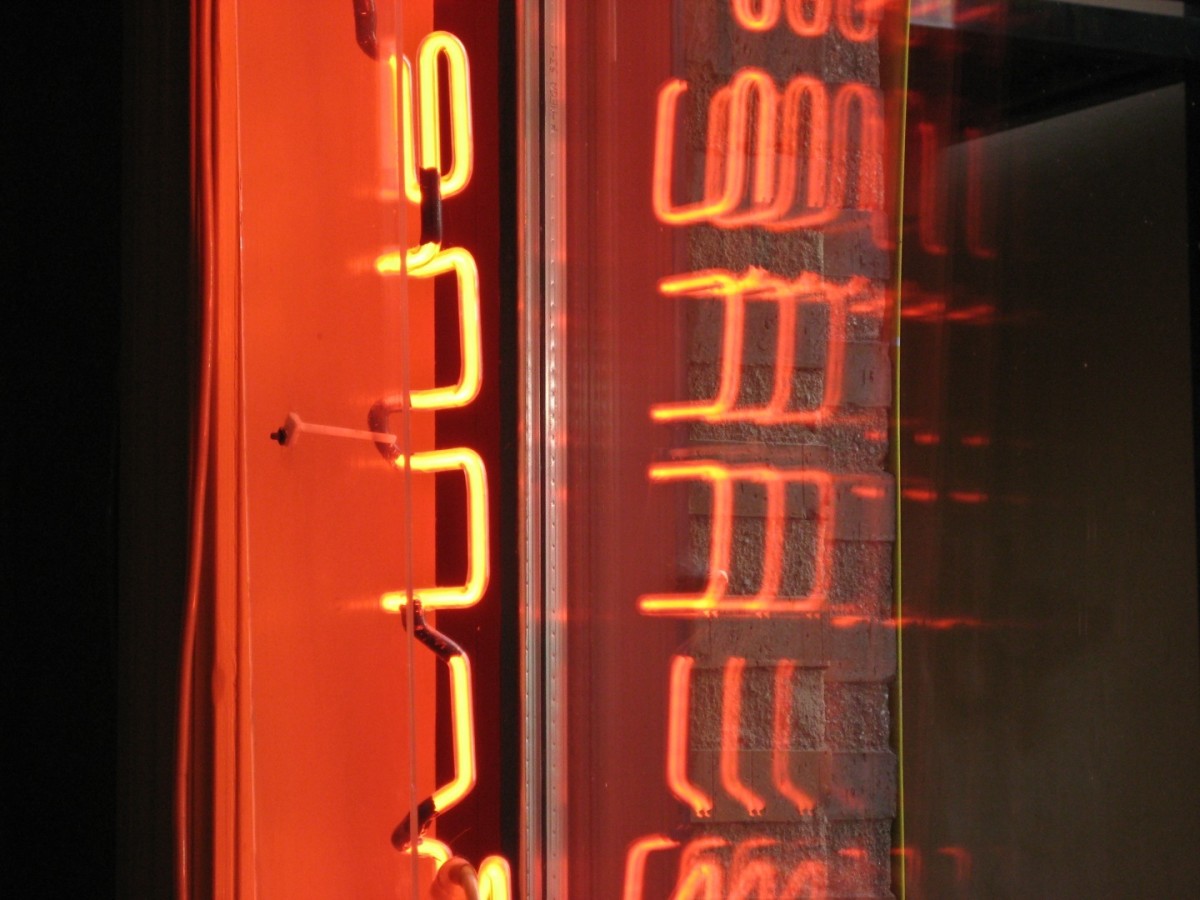 A red neon light has a different color spectrum than white light.