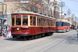 The original streetcar from my young days in front, with the newer current example behind.  Streetcars are still running in Toronto today.