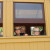 The kids peek their heads out of the train window. The kids peek their heads out of the train window.
