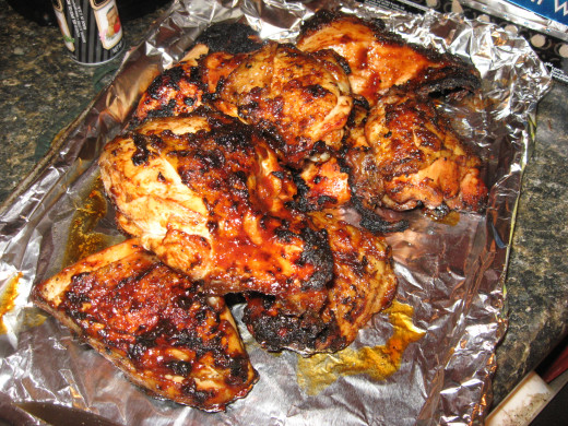 Remove cooked chicken from grill and add more sauce.