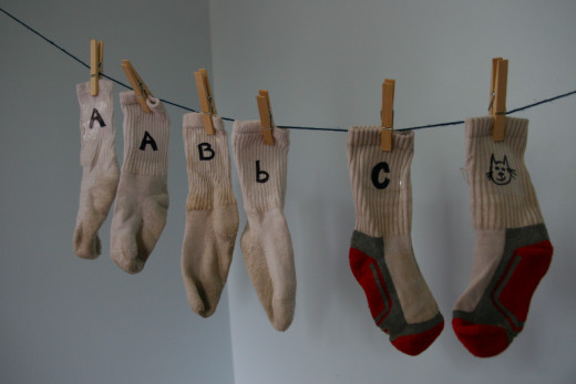Match socks on a clothesline to learn uppercase letters, lowercase letters, and letter sounds.