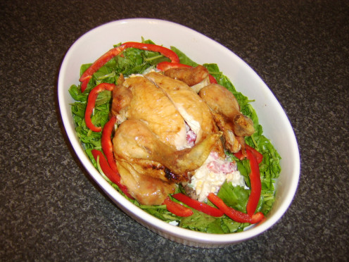 A whole chicken is roasted, cooled, portioned and reformed around a mound of potato salad