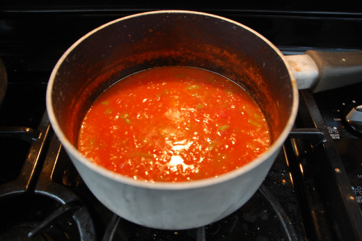 simmering the tomatoes, peppers and diced onions