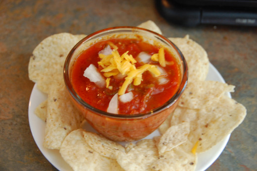 salsa garnished with fresh onion and freshly grated cheese