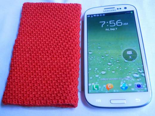 Here it is just beside the phone its meant to protect. Red... I love red.