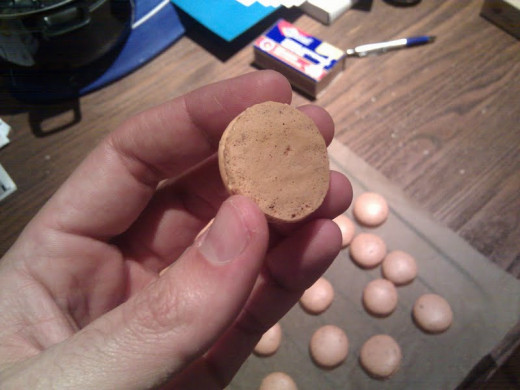 The macarons should slide off the parchment paper easily and yield a flat bottom like you see here. 