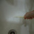 Using A Brush to Brush off Soap Scum from A Bathtub Using A Brush to Brush off Soap Scum from A Bathtub