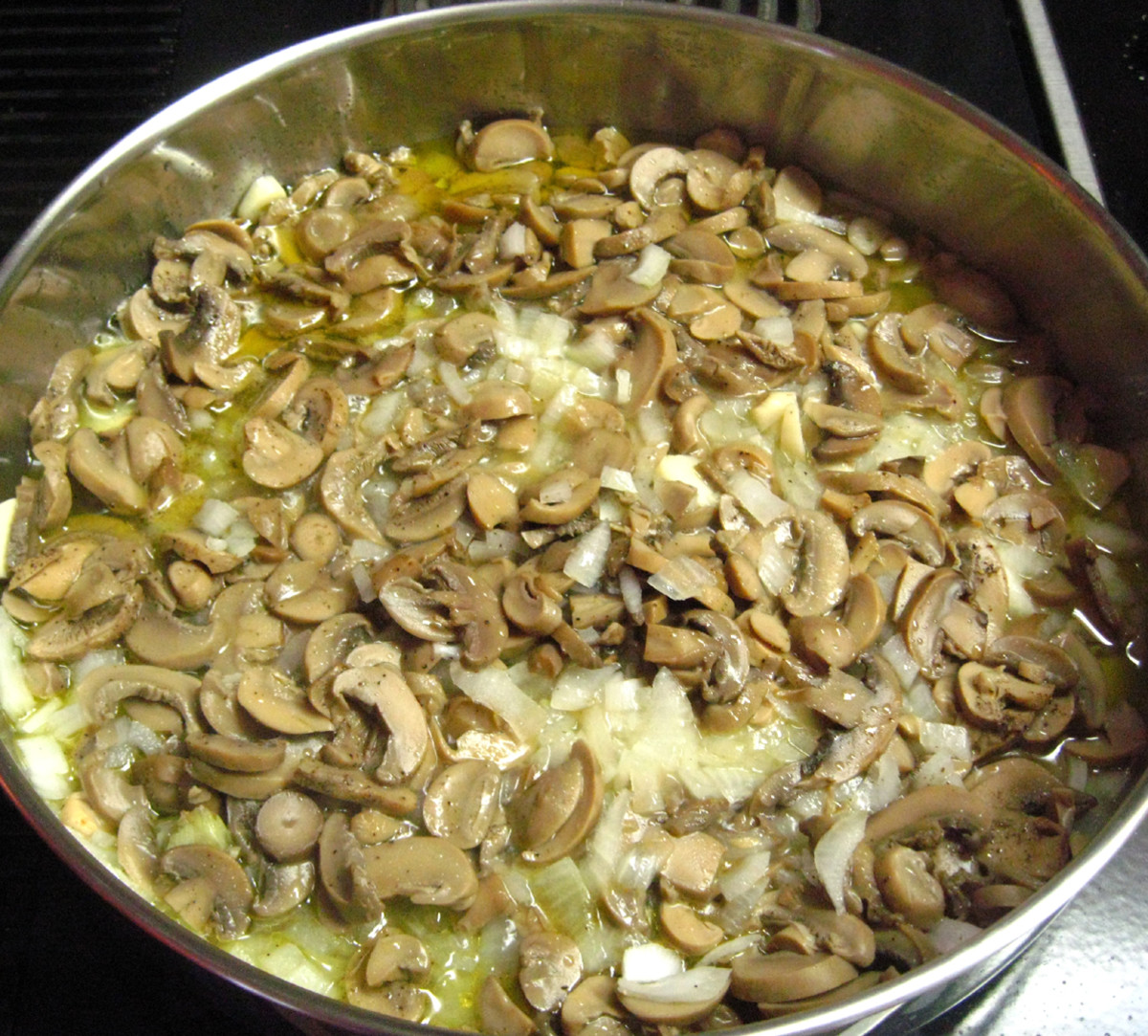 Saute' mushrooms, onions, and garlic in extra virgin olive oil. Simmer for about eight minutes.