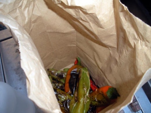 Dump the blackened peppers into a paper sack