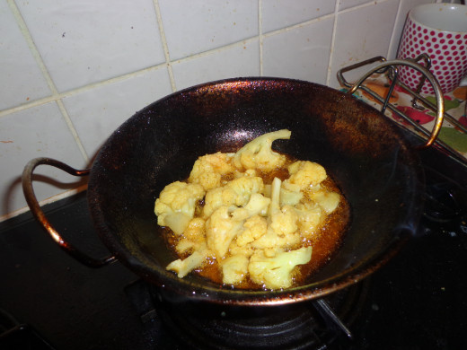 Cauliflower getting fried in the oil