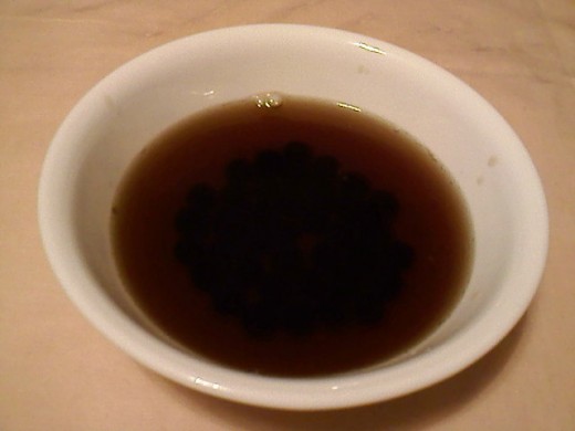 Cooked tapioca pearls in a bowl and boiled with brown sugar.