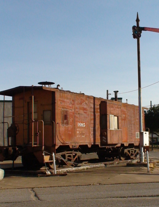 The semafore signal is one way to signal that a train is approaching a grade crossing. The flashing rear end device  (F.R.E.D.) on the end of a caboose signals the end of a train. 