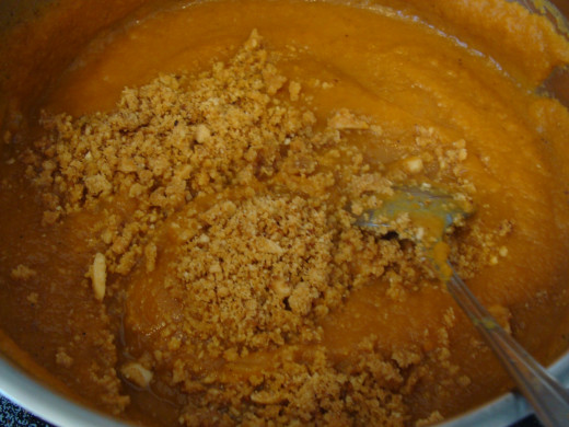 Add the spices and almonds to the pumpkin.