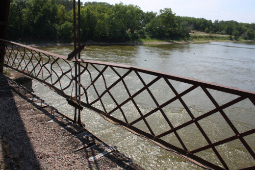 The railings and part of the floor of the bridge
