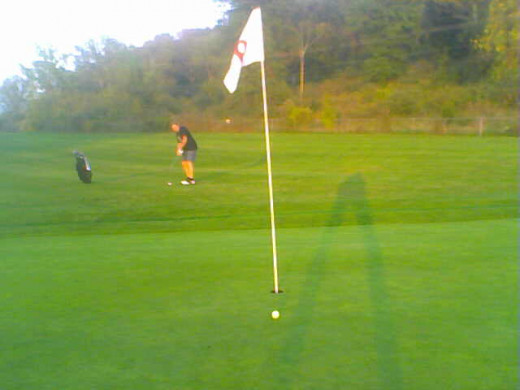 Calling it a day: The chartreuse ball a foot from the hole is how you want to end the day om the golf course.Unfortunately for the golfer pictured, it is not his ball.