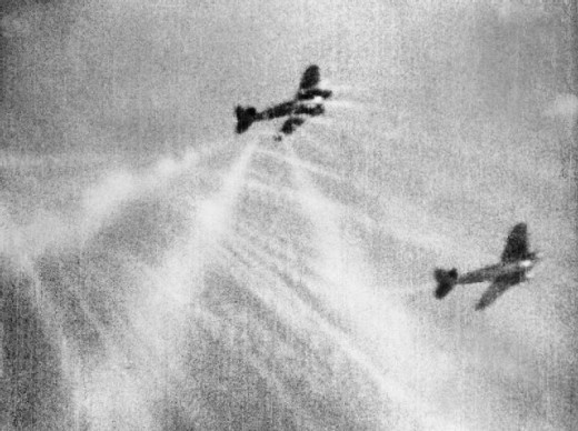 A still from camera gun film shows tracer ammunition from a Supermarine Spitfire Mark I of No. 609 Squadron RAF, flown by Flight Lieutenant J H G McArthur, hitting a Heinkel He 111 on its starboard quarter. These aircraft were part of a large formati