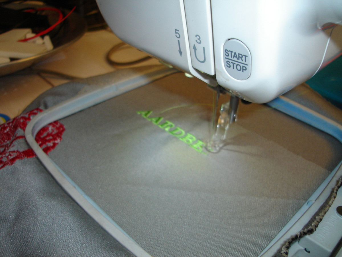This computerized sewing machine automatically sews embroidery designs onto the hooped fabric.
