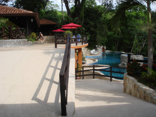 A view from the restaurant area toward the pool at Vandara.  There are massage tables and changing rooms on the upper level.