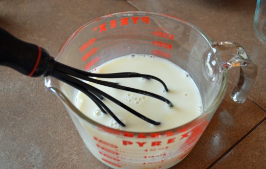 Stir together beaten eggs and milks, add in vanilla and then add cooled butter.  Mix well.