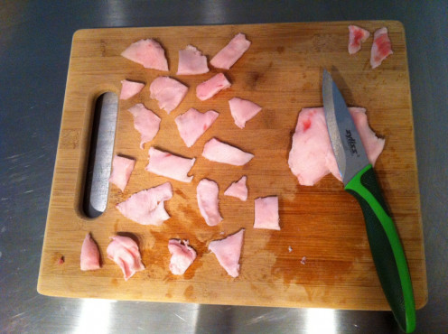 Cut the pork into smaller pieces, setting bits of meat and veins aside.