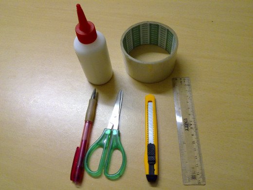 white glue, double-sided tape, pencil, scissors, penknife and ruler