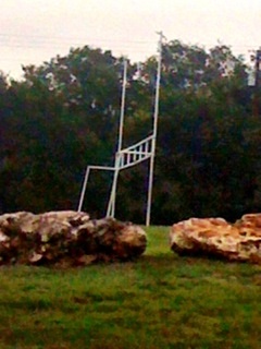 A local church football field uses large rocks for its borders. They provide a great place to sit and watch the games as well as a natural border so that cars do not drive into the area.