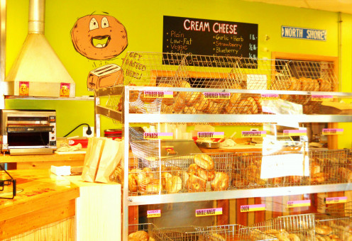 Appetizing display cases filled with bagels and pastries. 