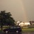 Rainbow by the street sign