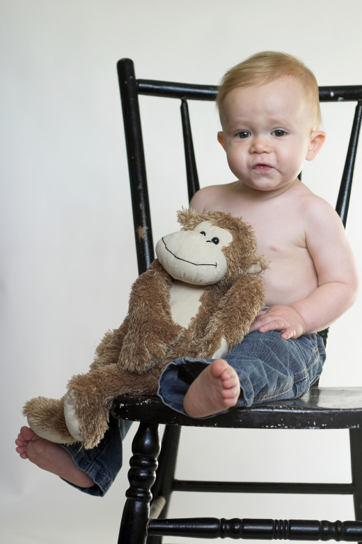 Monkey Boy by Beatricekillam  Image of a cute toddler sitting on a black chair, holding a stuffed monkey