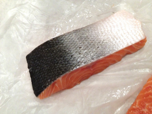 Don't worry about the salmon skin. It can be removed after the fish has cooked. It should easily be removed using a fork and a sliding motion.