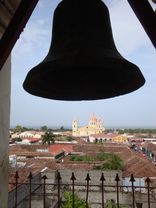 A view of the bell in the steeple at Iglesia de la Merced and the central Catholic Church in the background. Lake Nicaragua is about a half a kilometer behind the church.