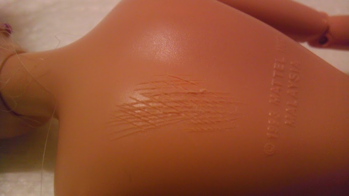 Scoring marks on Barbie's back, made with a craft knife