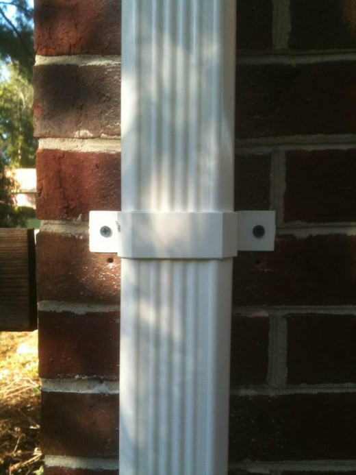 Downspout bracket secured using 3/16" anchor screws.