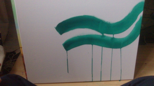 Using Green Acrylic paint to start to paint some curvy serpent shapes.