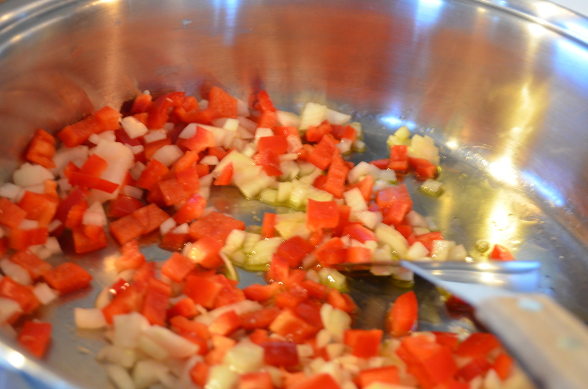 Sweat or sauté the red peppers and onions until they begin to wilt.