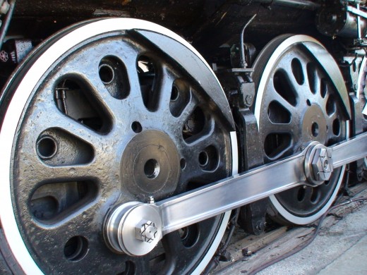 The wheels on the steam locomotive are huge