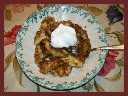 Crusted Dumplings with Cheese & Scallions, garnished with sour cream.    Source:  Sharyn's Slant