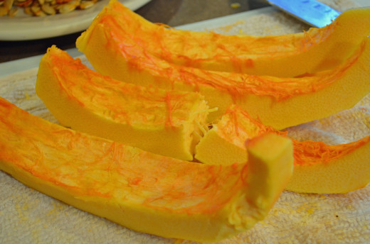 Working with 1/4 of pumpkin at a time, cut into strips.