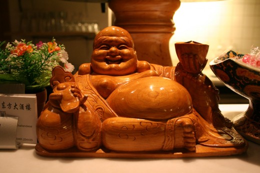 Laughing Buddha statues depict a stout, smiling or laughing bald man in robes with a largely exposed potbelly stomach, which symbolizes happiness, good luck, and plenitude :)