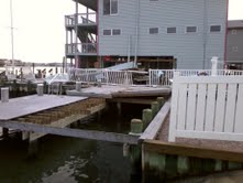 THE GRAY HOUSE IN THE BACK ROUND OF PHOTO HAS THE BOTTOM SIDE BLOWN OUT FROM THE SURGE OF THE WATER.