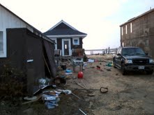 OUR NEIGHBOR ACROSS THE STREET. THINGS THROWN EVERYWHERE AFTER THE WATER SUBSIDED.