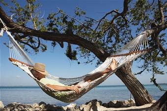 THIS MAN IS IN AN ENVIABLE PLACE: BEING LAZY IN A HAMMOCK.