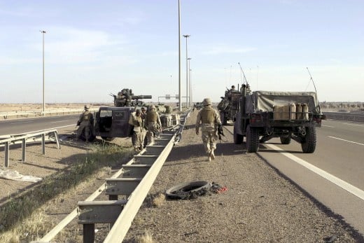 U.S. Marines with 2nd Battalion, 1st Marine Regiment, 1st Marine Division, use High-Mobility Multipurpose Wheeled Vehicles (HMMWV), one with an M220 Tow (Tube-launched, Optically-tracked, Wire-guided) System and Light Armored Vehicle-25 (LAV-25) to s