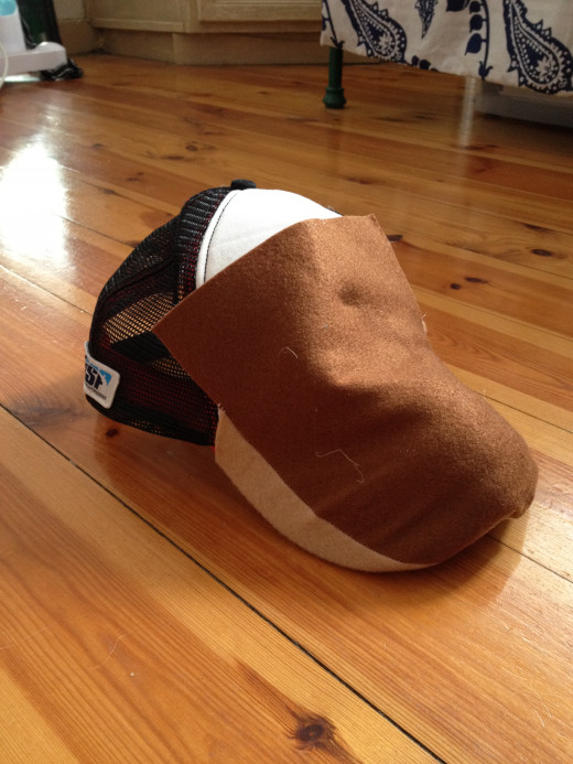 Make sure the top piece of felt is long enought ot cover the from of the cap