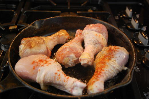 Browning the chicken legs in butter