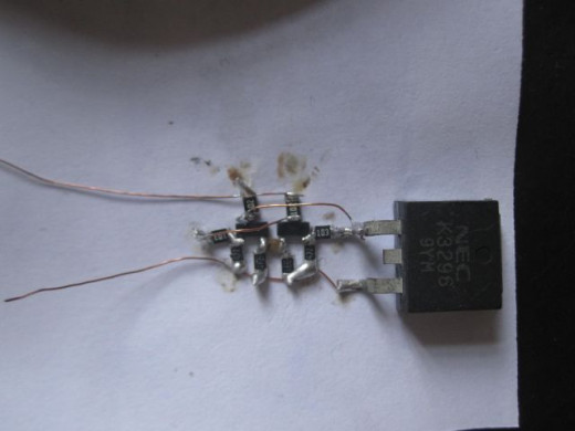 Wire up the SMD circuit using strands of copper wire.