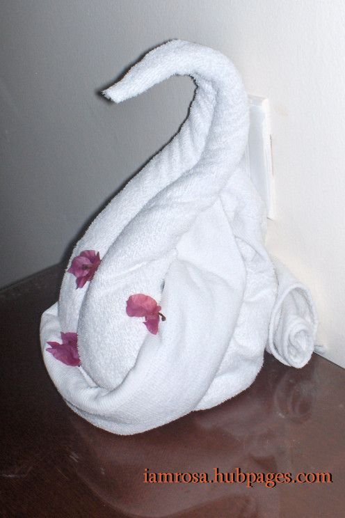 A swan made out of towels and face clothes.