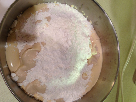 Whisk the flour, baking powder, and salt together in a large bowl. Add the wet ingredients to complete the batter. 